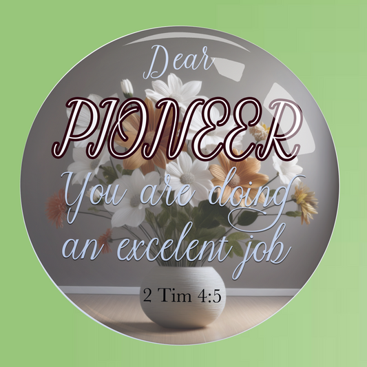 Round metal container with engraved text and floral design on a green background